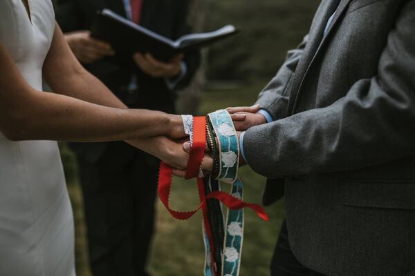 Handfasting with ribbons sourced in Paris was part of the ceremony. 